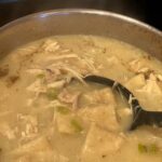 flat dumplings simmering in chicken broth